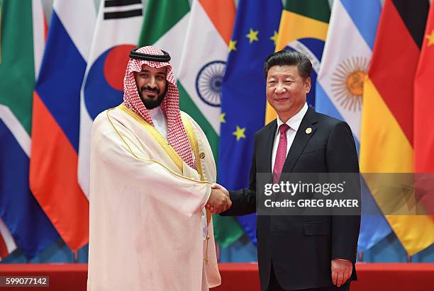 Saudi Arabia's Deputy Crown Prince and Minister of Defense Muhammad bin Salman Al Saud shakes hands with China's President Xi Jinping before the G20...