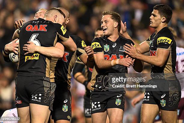 Peter Wallace of the Panthers celebrates scoring a try with team mates during the round 26 NRL match between the Penrith Panthers and the Manly Sea...