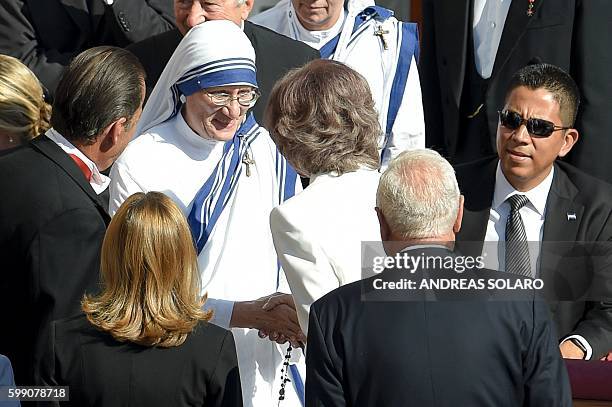 Sister Mary Prema Pierick , Superior General of the Missionaries of Charity of Kolkata, shakes hands with Queen Sophia of Spain as they attend the...