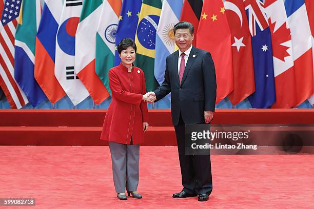 Chinese President Xi Jinping shakes hands with South Korean President Park Geun-Hye to the G20 Summit at the Hangzhou International Expo Center on...