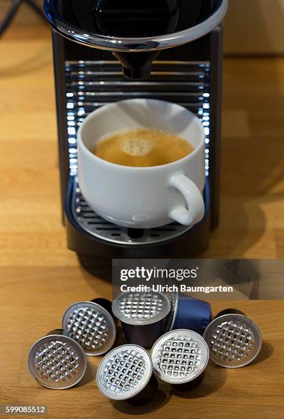 Coffee capsules for the quick and convenient coffee, but with problems for the environment. The picture shows used coffee capsules of metal in front...