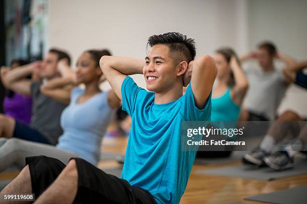 abdominal exercises in a fitness class - exercise class stock pictures, royalty-free photos & images