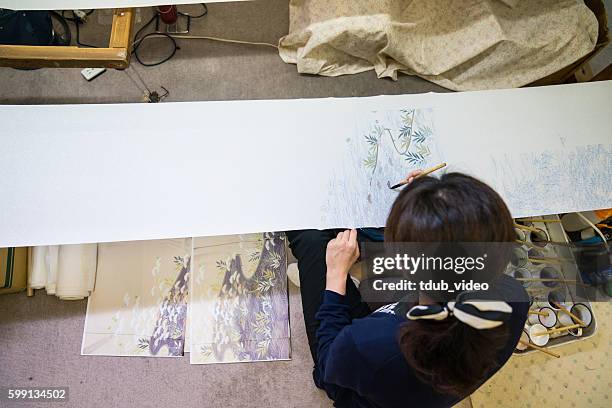 artisans paint designs onto raw kimono fabric in kyoto, japan - ink wash painting stock pictures, royalty-free photos & images