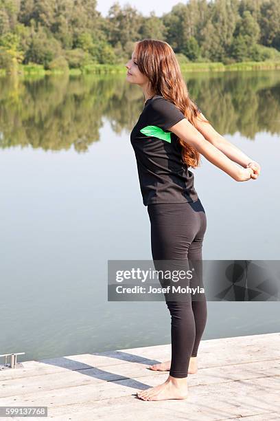 yong woman performs stretching relaxation - josef mohyla stock pictures, royalty-free photos & images