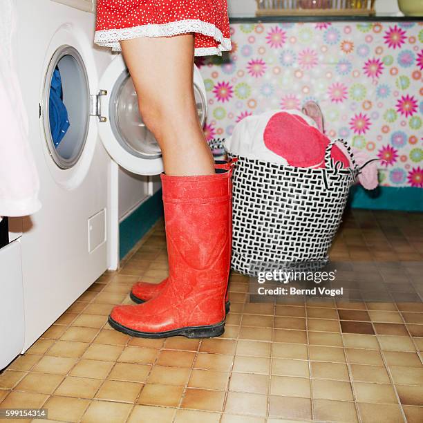 woman wearing red galoshes - wellington boots stock pictures, royalty-free photos & images