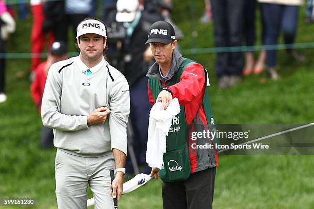 Bubba Watson with his caddie during the first hole of a play off the final round of the Travelers Championship at TPC River Highlands in Cromwell,...