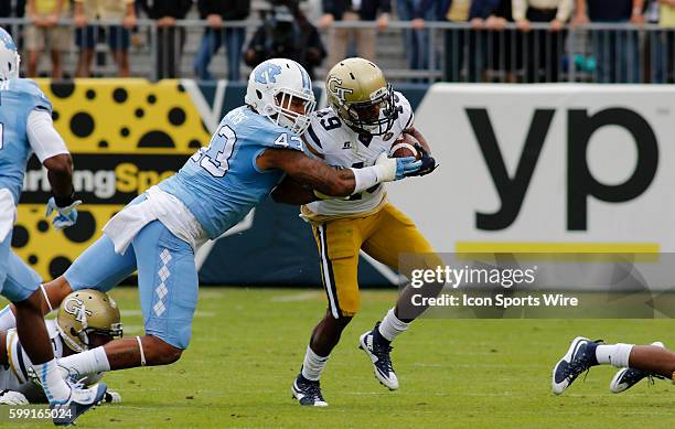 Clinton Lynch is tackled by Jessie Rogers during the NCAA football game between the UNC Tar Heels and the Georgia Tech Yellow Jackets at Bobby Dodd...