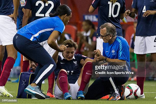 France midfielder Claire Lavogez is helped by medical staff during the 2015 FIFA Women's World Cup Quarter final match between Germany and France at...