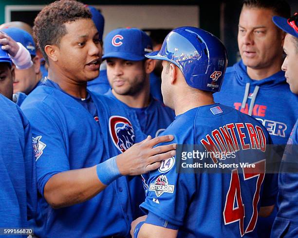Chicago Cubs shortstop Starlin Castro congratulates catcher Miguel Montero after Mntero scored a run during the second inning of game two of...