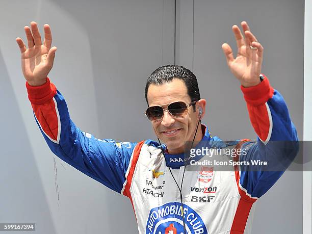 Team Penske driver Helio Castroneves waves to the fans on stage during driver introductions before the MAVTV 500 held at the Auto Club Speedway in...
