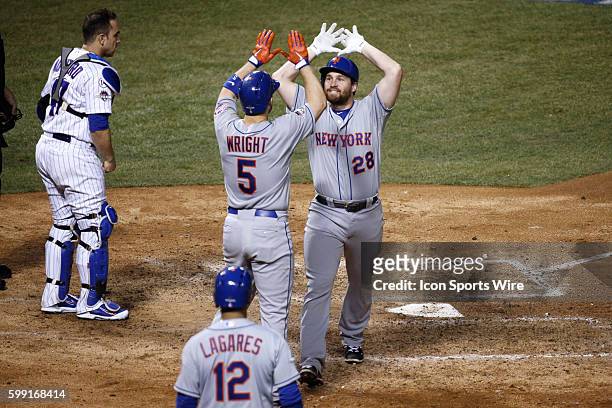 New York Mets second baseman Daniel Murphy celebrates with third baseman David Wright and center fielder Juan Lagares his two run home run in the...