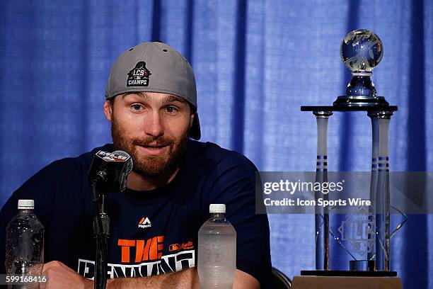 New York Mets second baseman Daniel Murphy talks to members of the media after being awarded the NLCS MVP award and trophy in a post game press...