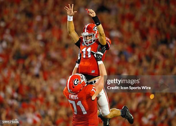 Georgia Bulldogs quarterback Greyson Lambert celebrates a touchdown with offensive tackle John Theus in the Georgia Bulldogs 52-20 victory over the...