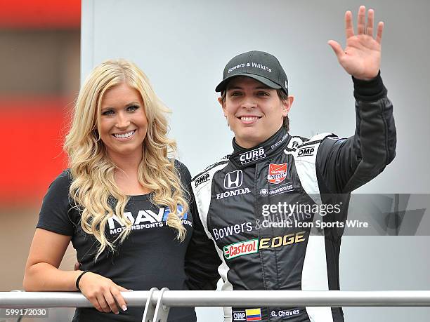 With Curb-Agajanian rookie driver Gabby Chaves waves to the fans while standing with a MAVTV girl during driver introductions before the start of the...