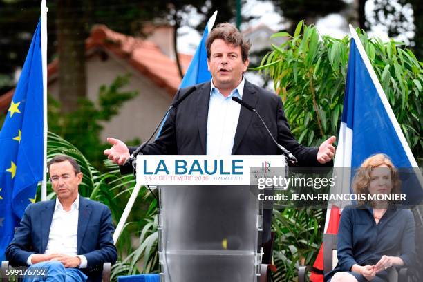 French lawmaker and right-wing "Les Republicains" party member Thierry Solere delivers a speech, flanked by French member of Parliament and candidate...