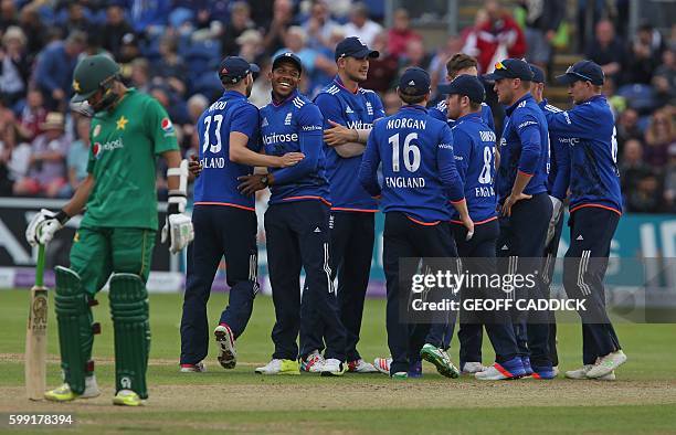 England players celebrate after taking the wicket of Pakistan's Sharjeel Khan during play in the fifth one day international cricket match between...