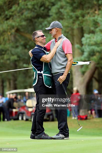 Andre Bossert of Switzerland is congratulated by his caddie after winning the Travis Perkins Masters played on the Duke's Course at Woburn Golf Club...