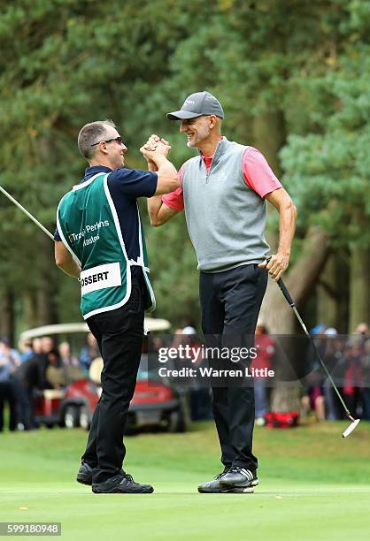 Andre Bossert of Switzerland is congratulated by his caddie after winning the Travis Perkins Masters played on the Duke's Course at Woburn Golf Club...