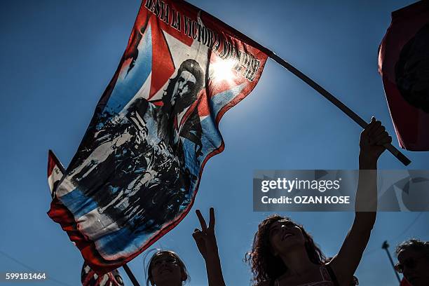 Woman holds a flag bearing a portrait of Argentine marxist revolutionary Ernesto Che Guevara during a peace rally against the war in Syria on...