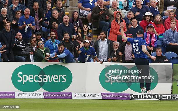 Member of the crowd catches a ball hit for six by Pakistan batsman Sarfraz Ahmed during play in the fifth one day international cricket match between...