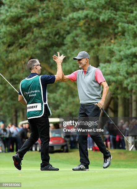 Andre Bossert of Switzerland is congratulated by his caddie after winning the Travis Perkins Masters played on the Duke's Course at Woburn Golf Club...