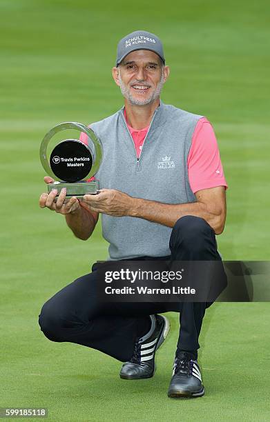 Andre Bossert of Switzerland poses with the trophy after winning the Travis Perkins Masters played on the Duke's Course at Woburn Golf Club on...