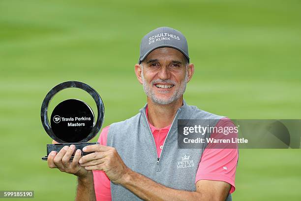 Andre Bossert of Switzerland poses with the trophy after winning the Travis Perkins Masters played on the Duke's Course at Woburn Golf Club on...