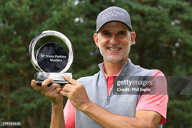 Andre Bossert of Switzerland poses with the trophy after the final round of the Travis Perkins Masters played on the Duke's Course, Woburn Golf Club...