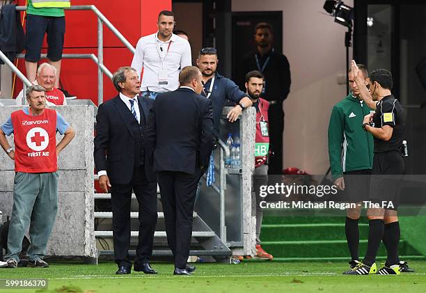 Jan Kozak head coach of Slovakia is spoken to by referee Milorad Mazic during the 2018 FIFA World Cup Group F qualifying match between Slovakia and...