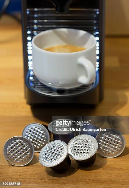 Coffee capsules for the quick and convenient coffee, but with problems for the environment. The picture shows used coffee capsules of metal in front...