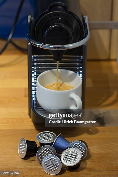 Coffee capsules for the quick and convenient coffee, but with problems for the environment. The picture shows used coffee capsules of metal in front...