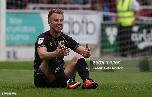 Dean Bowditch of Milton Keynes Dons sits dejected after conceding a penalty during the Sky Bet League One match between Northampton Town and Milton...