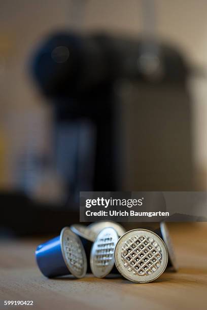 Coffee capsules for the quick and convenient coffee, but with problems for the environment. The picture shows used coffee capsules of metal in front...