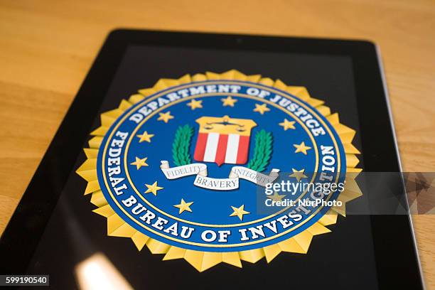An app is seen on an iOS device developed by the Federal Bureau of Investigation to help in the search for unidentified bank robbers. Bydgoszcz,...