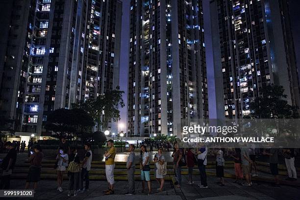 People queue to vote shortly before polls officialy close during the Legislative Council election in Hong Kong late on September 4, 2016. Young Hong...