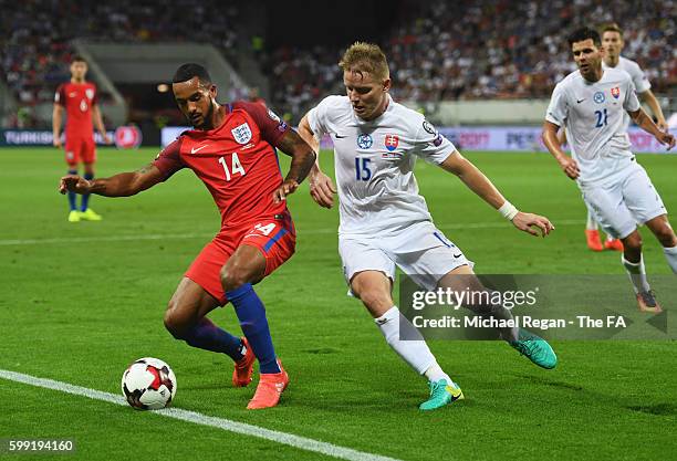 Theo Walcott of England holds off Tomas Hubocan of Slovakia during the 2018 FIFA World Cup Group F qualifying match between Slovakia and England at...