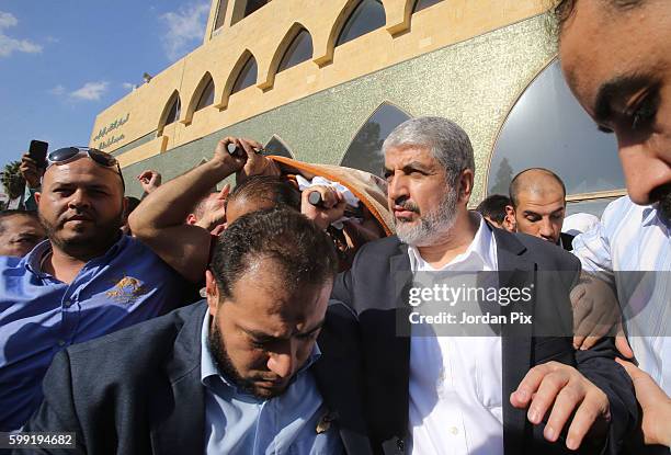 Khaled Mashal , the leader of the Islamic Palestinian organization HAMAS, raises the body of his mother during her funeral on September 4 in Amman,...