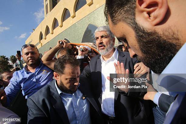 Khaled Mashal , the leader of the Islamic Palestinian organization HAMAS, raises the body of his mother during her funeral on September 4 in Amman,...