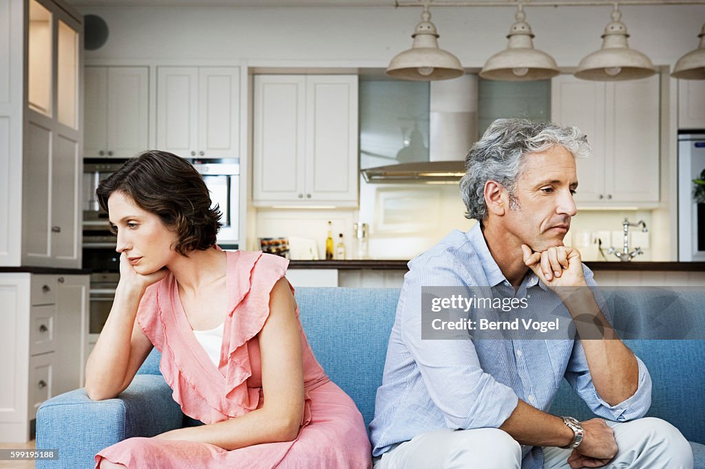 Sad couple sitting back to back