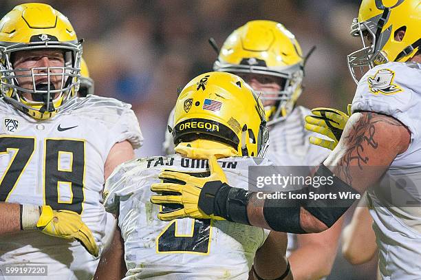 Oregon Ducks players wear a ribbon with he letters "UCC" as a memorial for victims of a school shooting at Umpqua Community College in Roseburg,...