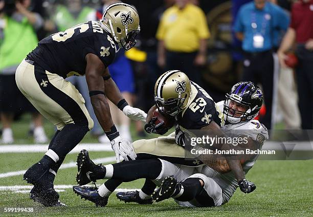 Brent Urban of the Baltimore Ravens tackles Marcus Murphy of the New Orleans Saints during a game at Mercedes-Benz Superdome on September 1, 2016 in...