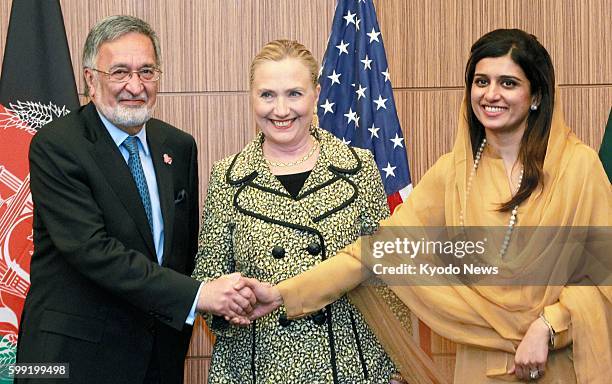 Japan - Afghan Foreign Minister Zalmai Rassoul, U.S. Secretary of State Hillary Clinton and Pakistani Foreign Minister Hina Rabbani Khar shake hands...