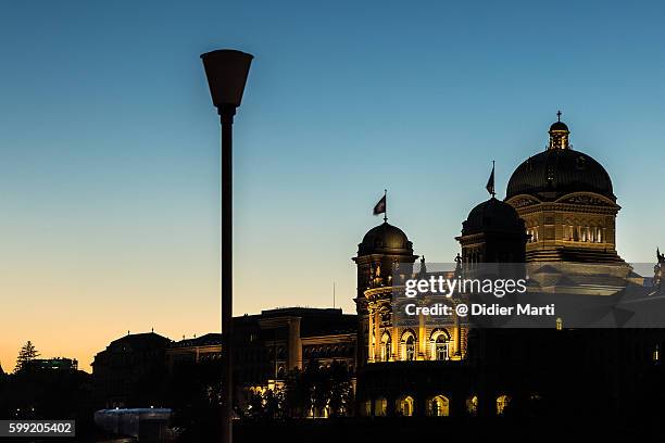 sunset over the swiss parliament house in berne - ville de berne photos et images de collection