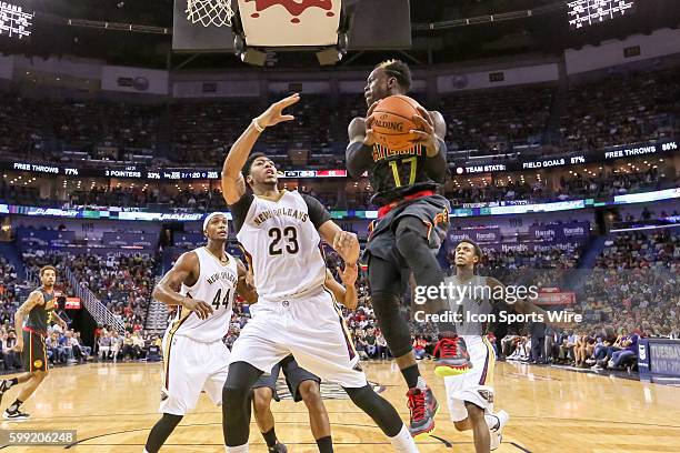 Atlanta Hawks guard Dennis Schroder looks to pass the ball around New Orleans Pelicans forward Anthony Davis during the game between Atlanta Hawks...