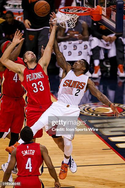 New Orleans Pelicans forward Ryan Anderson goes against Phoenix Suns guard Eric Bledsoe for a rebound during the game between the Phoenix Suns and...