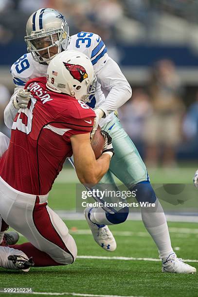 Dallas Cowboys cornerback Brandon Carr tackles Arizona Cardinals tight end John Carlson during a football game between the Dallas Cowboys and Arizona...