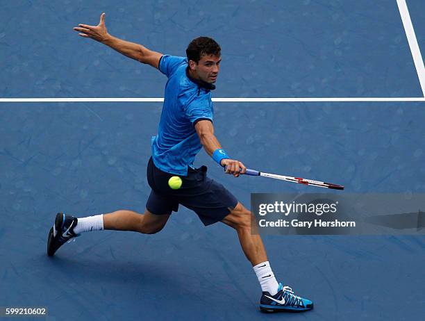 Grigor Dimitrov of Bulgaria hits to Gael Monfils of France in their match at the US Open tennis championship in New York, September 2, 2014.