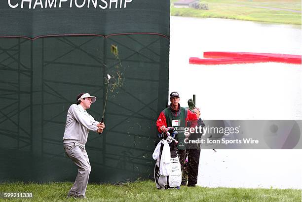 Bubba Watson and caddy Ted Scott watch his third shot on 17 during the final round of the Travelers Championship at TPC River Highlands in Cromwell,...