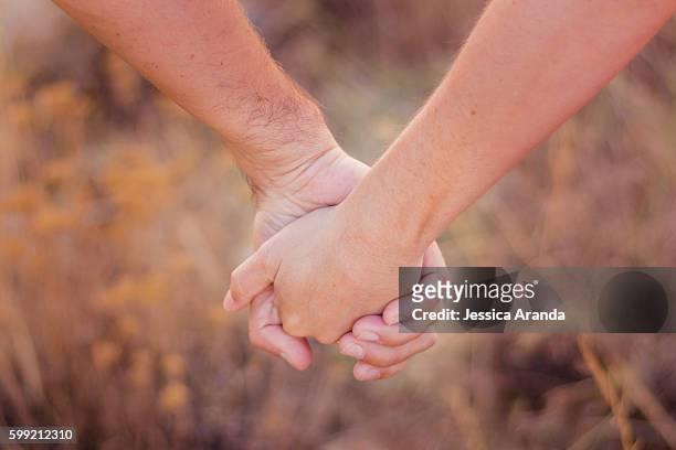 love is in our hands, not just in our hearts - parejas stock pictures, royalty-free photos & images