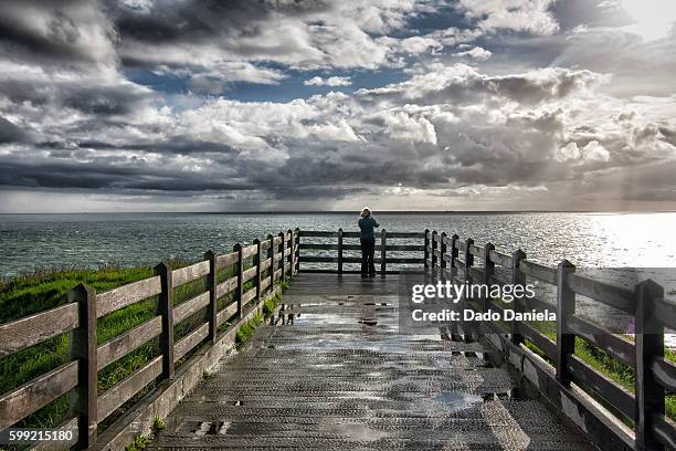 girl at the balcony - nord pas de calais stock pictures, royalty-free photos & images